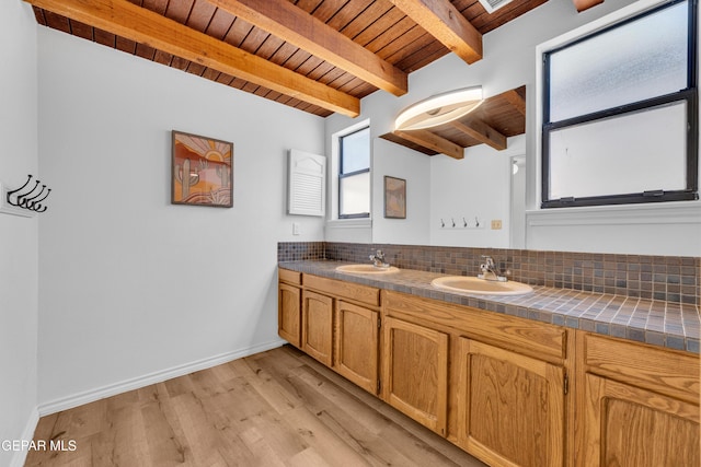 724 Gary Ln, El Paso, TX 79922 - bathroom featuring wood ceiling with exposed beams, double vanity, wood finished floors, backsplash, and baseboards