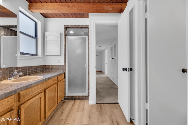 724 Gary Ln, El Paso, TX 79922 - full bathroom featuring a shower stall, vanity, wooden ceiling with exposed beams, wood finished floors, and tasteful backsplash