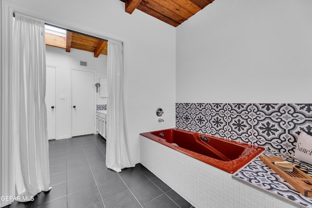 724 Gary Ln, El Paso, TX 79922 - bathroom featuring wood ceiling, a garden tub, tile patterned flooring, and a wainscoted wall