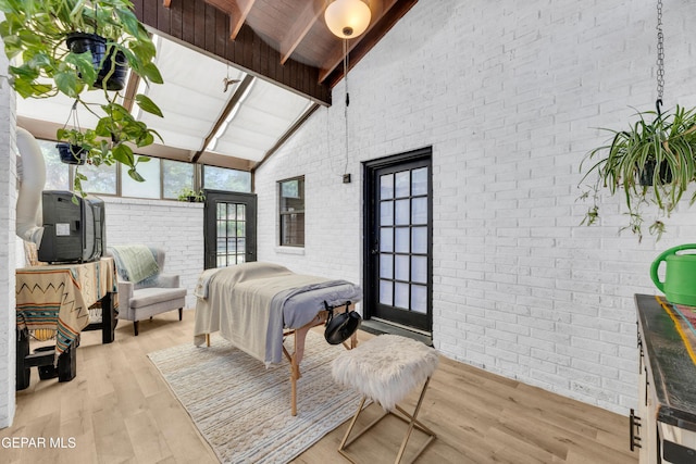 724 Gary Ln, El Paso, TX 79922 - bedroom featuring brick wall, wood finished floors, high vaulted ceiling, and wood ceiling with exposed beams