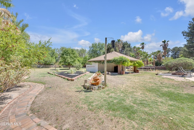 724 Gary Ln, El Paso, TX 79922 - view of green lawn featuring a garden and an outdoor fire pit