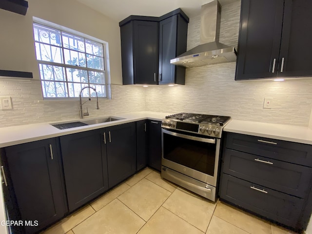 350 Thunderbird Dr Unit F45, El Paso, TX 79912 - kitchen with wall chimney exhaust hood, stainless steel range with gas stovetop, a sink, and light tile patterned floors