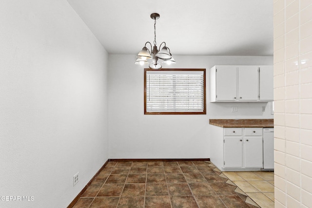 5609 Paradise Ln, El Paso, TX 79924 - unfurnished dining area with a chandelier and baseboards
