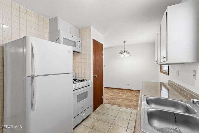 5609 Paradise Ln, El Paso, TX 79924 - kitchen featuring white appliances, a sink, a chandelier, white cabinetry, and light tile patterned floors