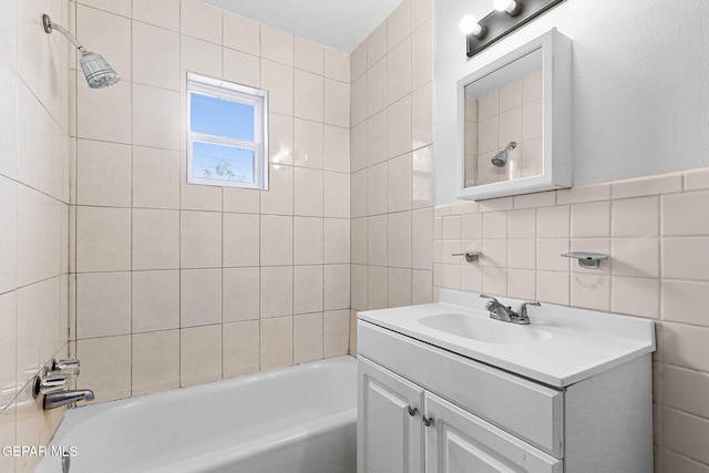 5609 Paradise Ln, El Paso, TX 79924 - full bathroom featuring vanity, shower / bath combination, and tile walls