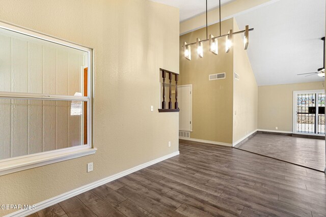 5261 Roger Maris Dr, El Paso, TX 79934 - unfurnished dining area with ceiling fan, dark wood-style floors, baseboards, and lofted ceiling