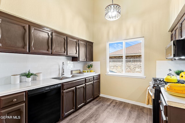 5261 Roger Maris Dr, El Paso, TX 79934 - kitchen with dishwasher, a sink, stainless steel microwave, range with gas stovetop, and dark brown cabinetry