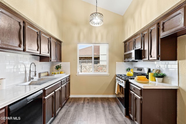 5261 Roger Maris Dr, El Paso, TX 79934 - kitchen featuring appliances with stainless steel finishes, a sink, dark brown cabinetry, and high vaulted ceiling