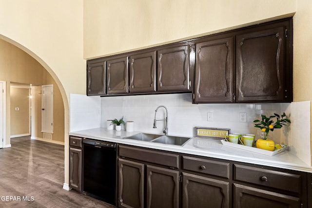 5261 Roger Maris Dr, El Paso, TX 79934 - kitchen with black dishwasher, a sink, arched walkways, dark brown cabinets, and light countertops