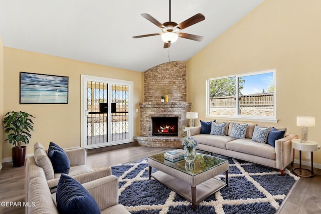 5261 Roger Maris Dr, El Paso, TX 79934 - living room featuring lofted ceiling, a ceiling fan, plenty of natural light, wood finished floors, and a brick fireplace