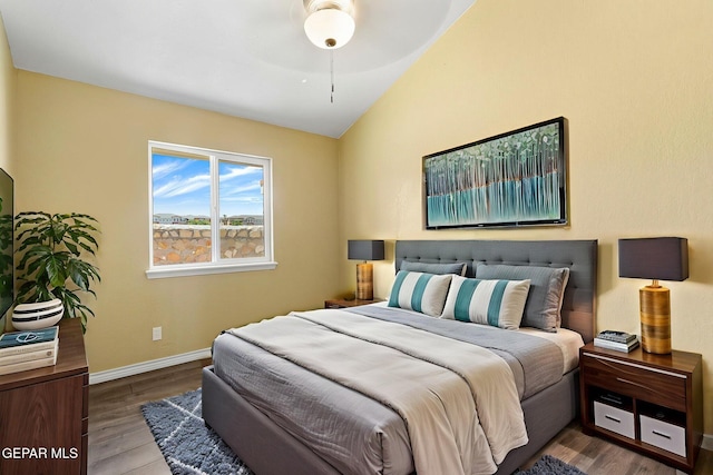 5261 Roger Maris Dr, El Paso, TX 79934 - bedroom with baseboards, wood finished floors, and lofted ceiling
