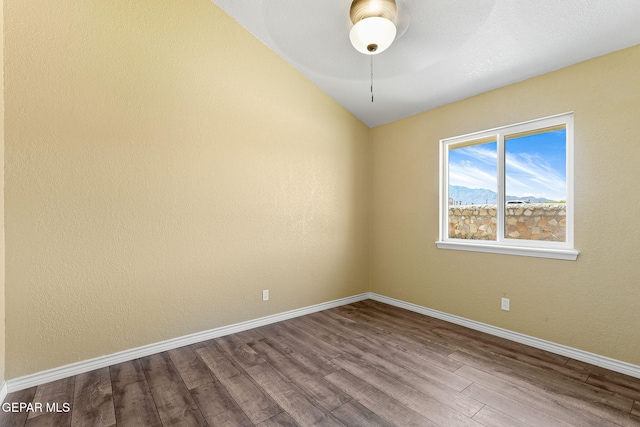 5261 Roger Maris Dr, El Paso, TX 79934 - unfurnished room with dark wood-type flooring, baseboards, lofted ceiling, and ceiling fan