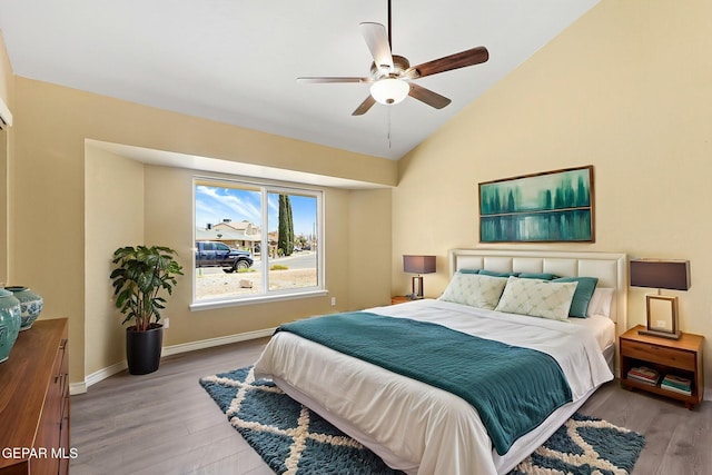 5261 Roger Maris Dr, El Paso, TX 79934 - bedroom featuring wood finished floors, vaulted ceiling, baseboards, and a ceiling fan