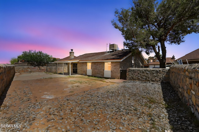 5261 Roger Maris Dr, El Paso, TX 79934 - view of side of property with a fenced backyard, a chimney, a patio, and brick siding