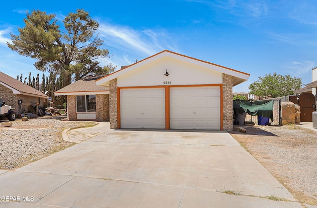 5261 Roger Maris Dr, El Paso, TX 79934 - ranch-style house featuring driveway, a garage, and brick siding