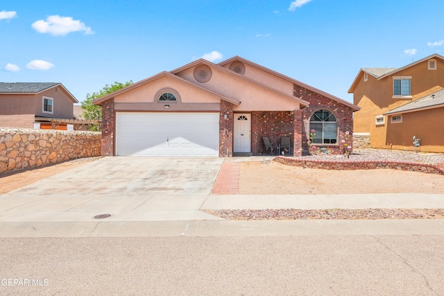 7009 Falling Leaf Cir, El Paso, TX 79934 - view of front of house with a garage, concrete driveway, brick siding, and stucco siding
