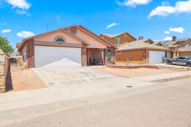 7009 Falling Leaf Cir, El Paso, TX 79934 - view of front facade featuring driveway, an attached garage, and brick siding