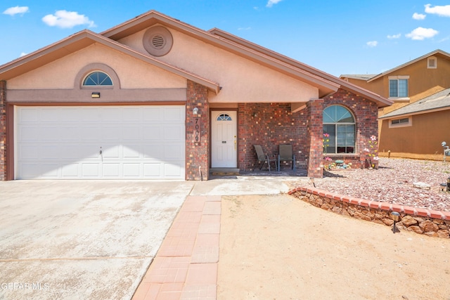 7009 Falling Leaf Cir, El Paso, TX 79934 - view of front facade featuring brick siding, driveway, and a garage