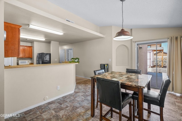 7009 Falling Leaf Cir, El Paso, TX 79934 - dining area with baseboards and a textured ceiling