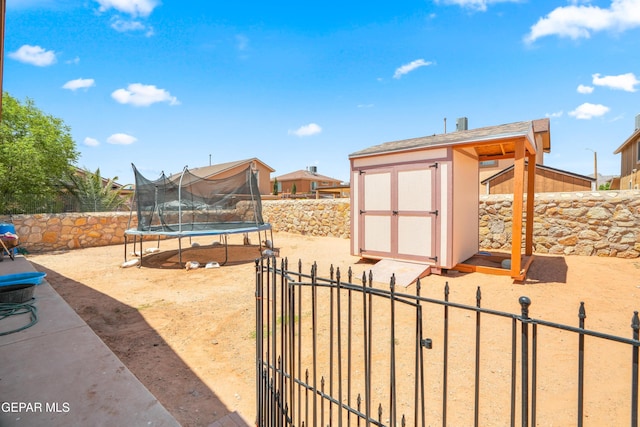 7009 Falling Leaf Cir, El Paso, TX 79934 - fenced backyard with a trampoline and a gate