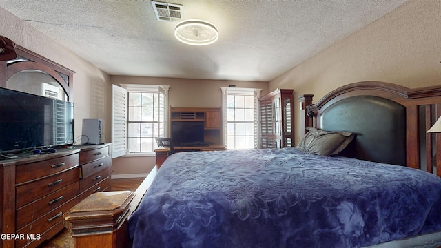 492 Country Oaks Dr, El Paso, TX 79932 - bedroom with a textured ceiling, baseboards, and dark wood finished floors