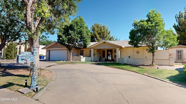 492 Country Oaks Dr, El Paso, TX 79932 - ranch-style home with covered porch, asphalt driveway, and a garage
