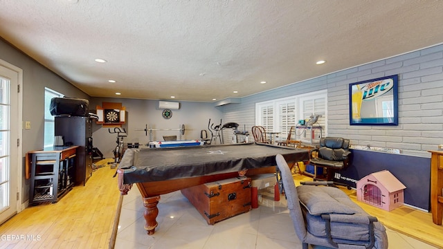 492 Country Oaks Dr, El Paso, TX 79932 - rec room with a textured ceiling, an AC wall unit, pool table, recessed lighting, and light wood-type flooring