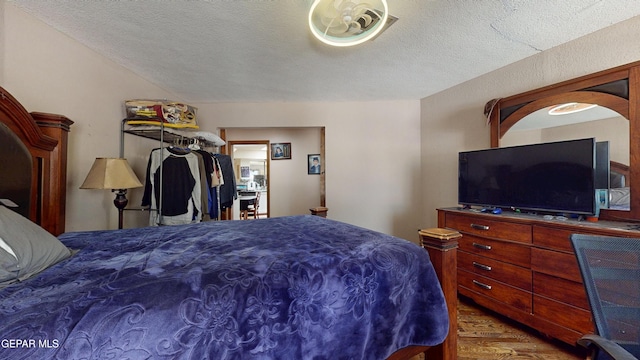 492 Country Oaks Dr, El Paso, TX 79932 - bedroom featuring wood finished floors and a textured ceiling