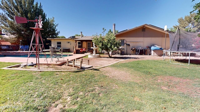 492 Country Oaks Dr, El Paso, TX 79932 - rear view of property with a trampoline, a lawn, and a patio area