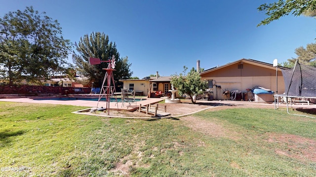 492 Country Oaks Dr, El Paso, TX 79932 - view of grassy yard with a trampoline and a patio