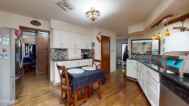 492 Country Oaks Dr, El Paso, TX 79932 - kitchen featuring appliances with stainless steel finishes, dark countertops, tasteful backsplash, and wood finished floors