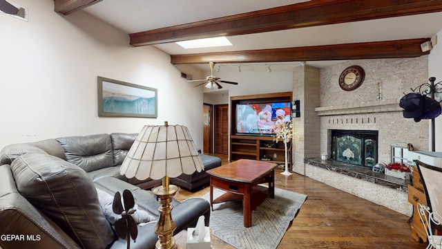 492 Country Oaks Dr, El Paso, TX 79932 - living area featuring wood finished floors, a fireplace, beamed ceiling, and a ceiling fan