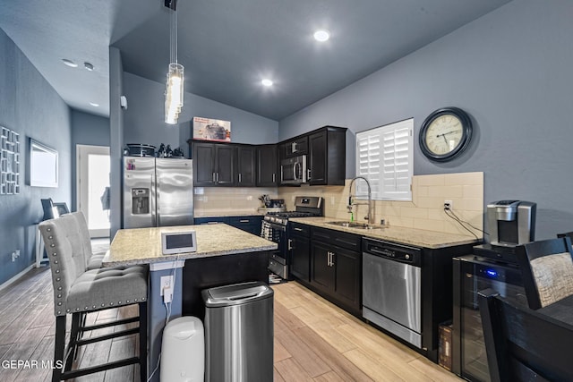 12805 Epsom Dr, Horizon City, TX 79928 - kitchen featuring stainless steel appliances, a sink, tasteful backsplash, light stone countertops, and lofted ceiling
