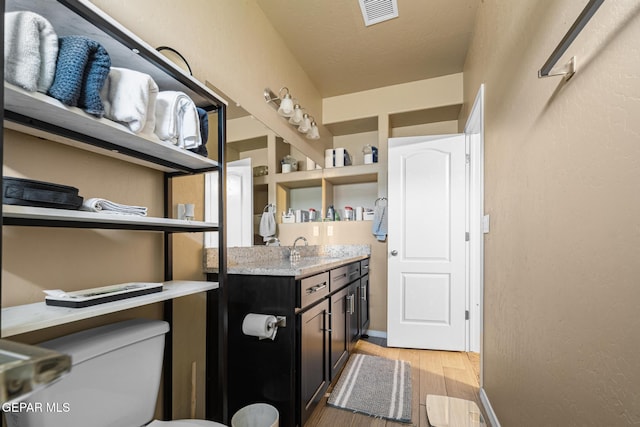 12805 Epsom Dr, Horizon City, TX 79928 - bathroom with wood finished floors, vanity, toilet, and baseboards