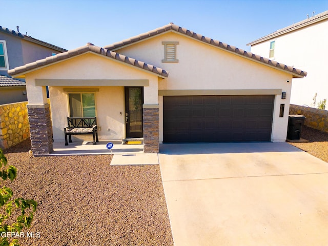 12805 Epsom Dr, Horizon City, TX 79928 - mediterranean / spanish-style home featuring stucco siding, a garage, concrete driveway, and a tile roof