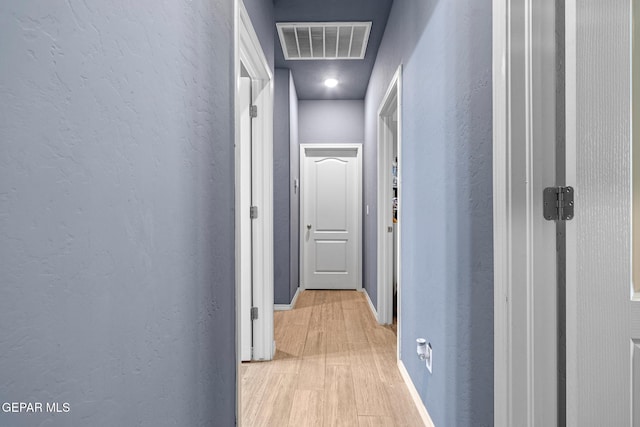 12805 Epsom Dr, Horizon City, TX 79928 - hall featuring a textured wall, light wood-style floors, and baseboards