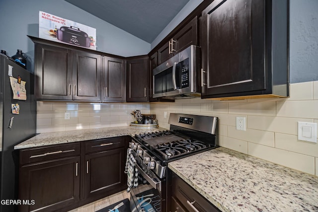 12805 Epsom Dr, Horizon City, TX 79928 - kitchen featuring stainless steel appliances, vaulted ceiling, tasteful backsplash, and dark brown cabinets