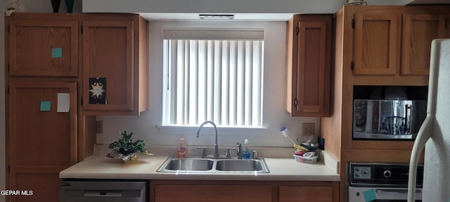 5121 Orleans Ave, El Paso, TX 79924 - kitchen featuring dishwasher, a sink, oven, and light countertops