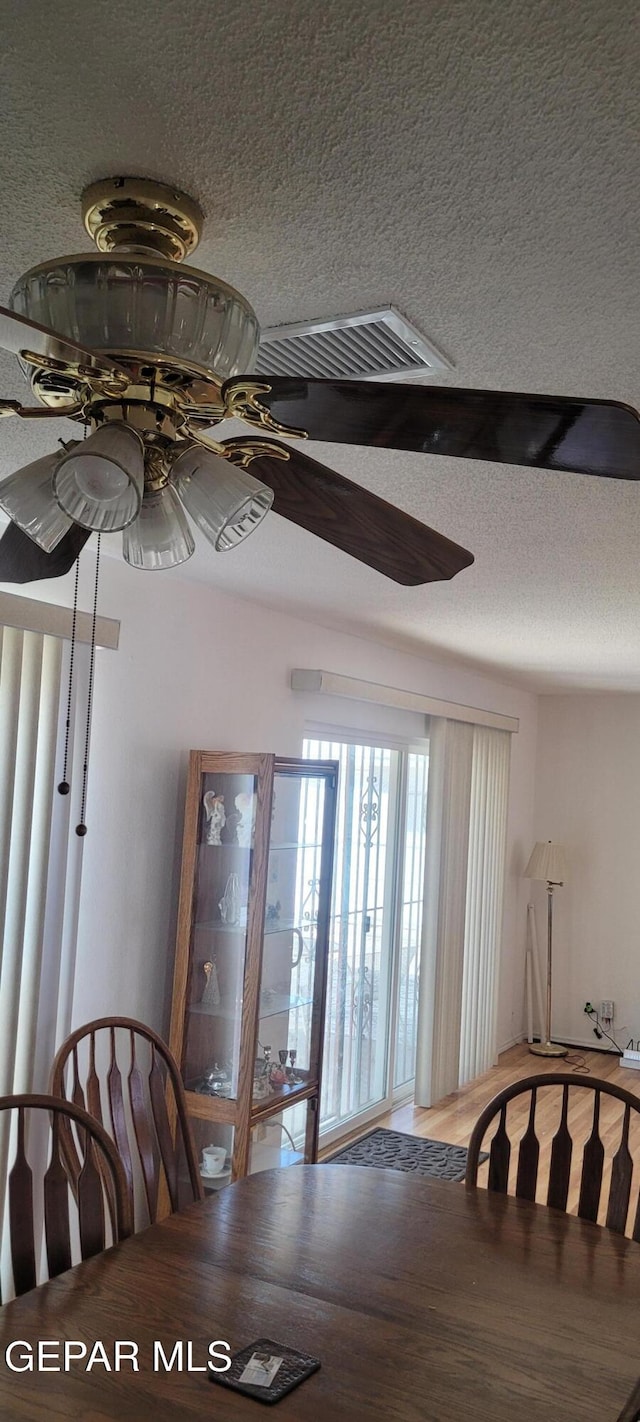 5121 Orleans Ave, El Paso, TX 79924 - dining area with ceiling fan, a textured ceiling, and wood finished floors