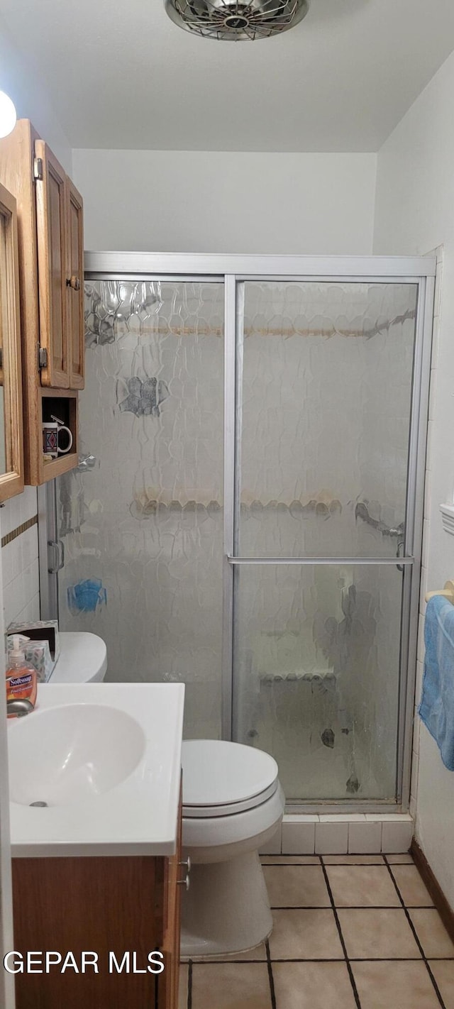 5121 Orleans Ave, El Paso, TX 79924 - full bathroom with vanity, toilet, tile patterned floors, and a shower stall