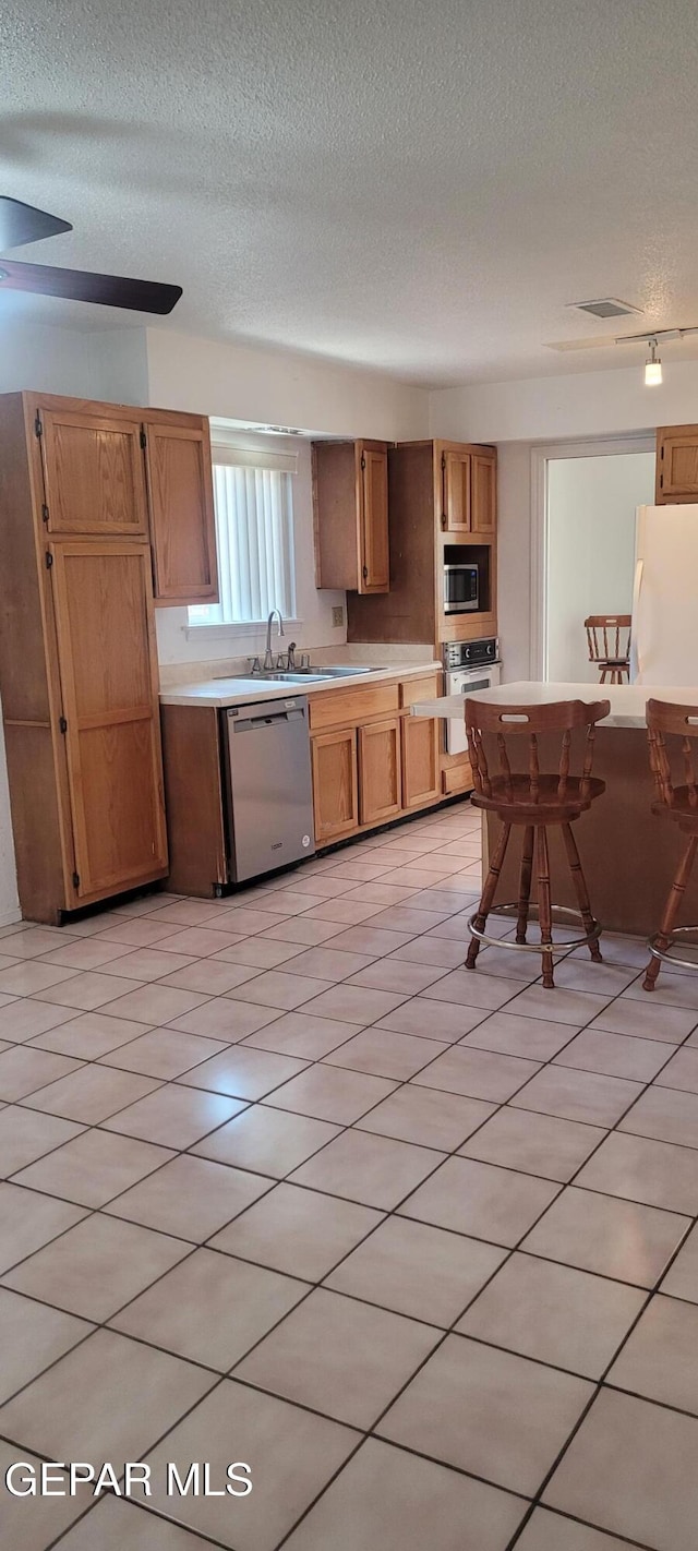 5121 Orleans Ave, El Paso, TX 79924 - kitchen featuring appliances with stainless steel finishes, a textured ceiling, and light countertops