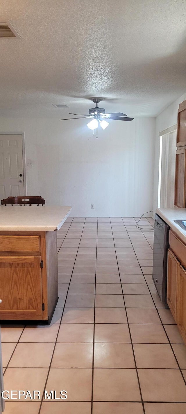 5121 Orleans Ave, El Paso, TX 79924 - kitchen with dishwasher, a ceiling fan, a textured ceiling, light countertops, and light tile patterned floors