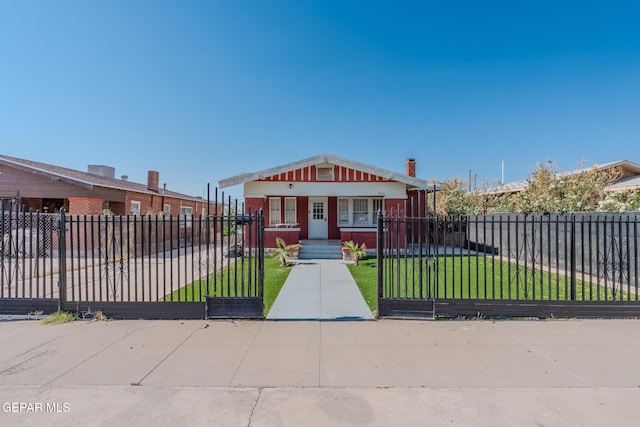 2712 Federal Ave, El Paso, TX 79930 - bungalow with a porch, a gate, a chimney, and brick siding