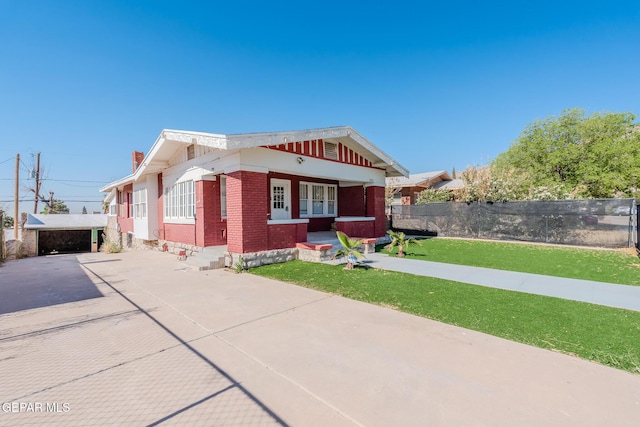 2712 Federal Ave, El Paso, TX 79930 - view of front of house featuring brick siding, driveway, a porch, and a chimney