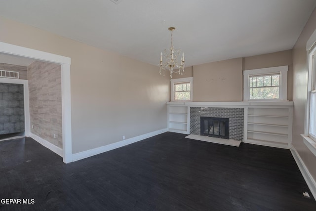 2712 Federal Ave, El Paso, TX 79930 - unfurnished living room with a glass covered fireplace, baseboards, dark wood-style flooring, and healthy amount of natural light