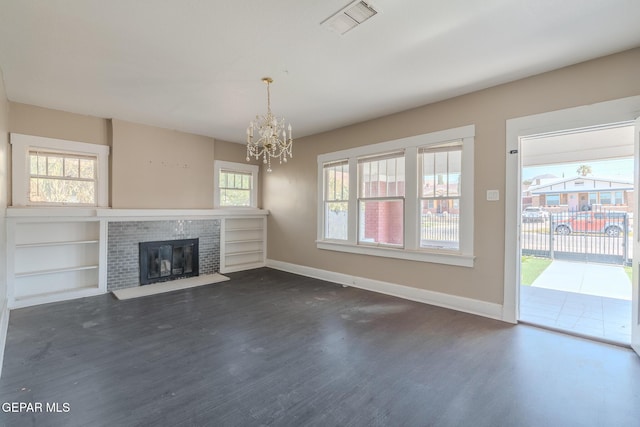 2712 Federal Ave, El Paso, TX 79930 - unfurnished living room featuring a chandelier, dark wood-style floors, baseboards, and a fireplace