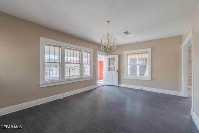 2712 Federal Ave, El Paso, TX 79930 - unfurnished dining area featuring a chandelier, dark wood-style floors, and baseboards