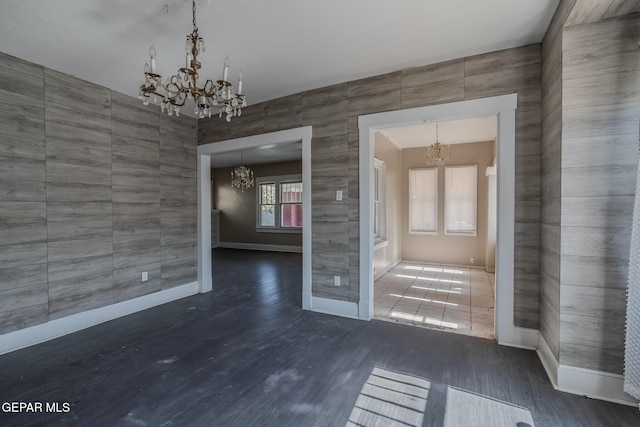 2712 Federal Ave, El Paso, TX 79930 - spare room with a chandelier, baseboards, and wood finished floors