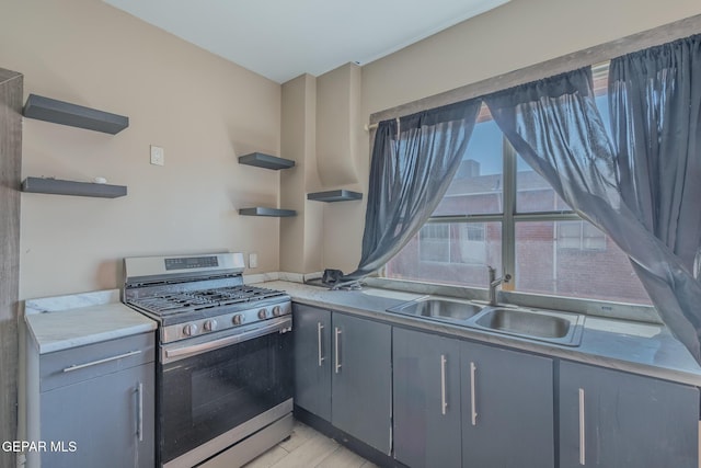 2712 Federal Ave, El Paso, TX 79930 - kitchen with open shelves, gas range, a sink, and light countertops