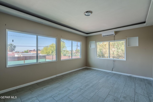 2712 Federal Ave, El Paso, TX 79930 - empty room with a wall mounted AC, baseboards, and wood finish floors